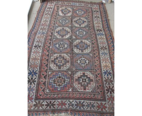 A Kasak rug, the central panel set with repeating tile decoration on a cream and pale pink ground, within a stepped pale pink