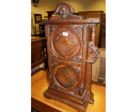 A 19th Century mahogany single door cupboard with carved and moulded pediment above a single door with two circular panels, a