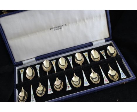 A set of late 20th Century silver gilt and enamel decorated teaspoons, each spoon with a different flower stem to include for