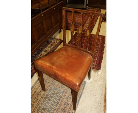 A set of twelve mahogany framed dining chairs with carved and pierced triple stick backs inlaid with floral motifs, raised on