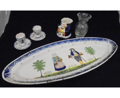 Five pieces of Quimper faience pottery wares including an oval serving dish, two egg cups, two plates, together with a simila