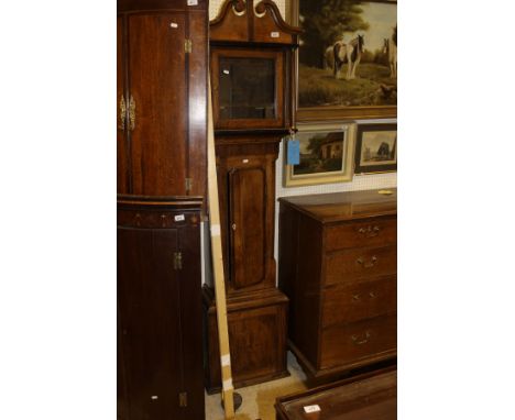 A late 19th Century North Country oak and mahogany banded long case clock with swan neck pediment above the brass dial with s