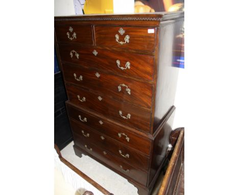 A Georgian mahogany chest on chest, the dentil carved pediment above a top of two short and three long drawers, each with bra