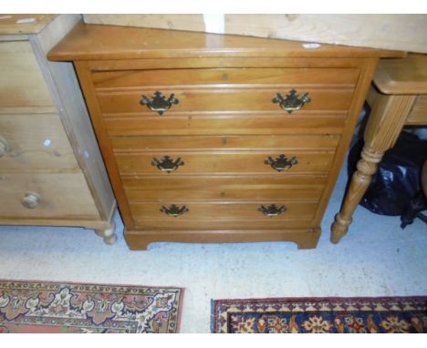 An Edwardian satin walnut chest of three long drawers raised on bracket feet