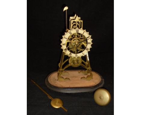 A brass skeleton clock with Roman numerals to the dial