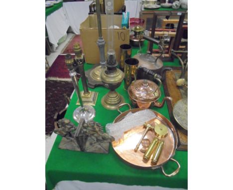 A selection of copper and brassware to include lamp standard, two table lamps, oil lamp, pair of iron "horse" bookends, sauce