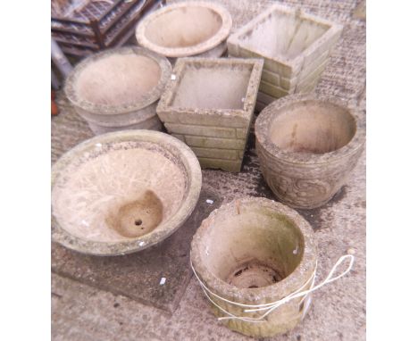 A collection of seven various composite stone garden pots