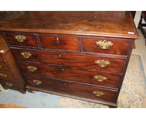 An early 19th Century mahogany chest of drawers, the plain top above three short drawers over three long drawers with brass s