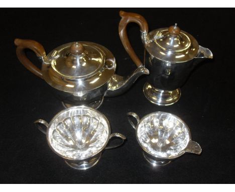 A matched four piece tea and coffee service, the teapot, cream jug and sugar pot (by Henry Clifford Davis, Birmingham 1931), 