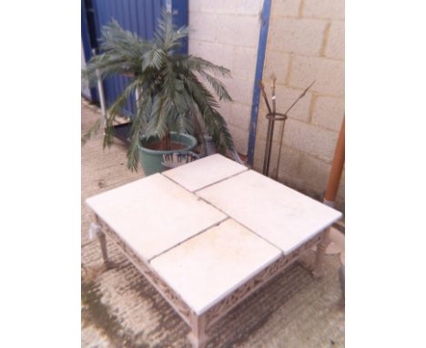 A green glazed garden planter, a tile topped square garden coffee table, a water pump, a synthetic plant etc