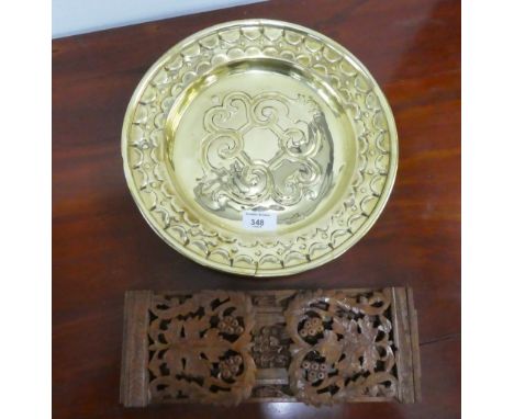 Carved wooden book trough together with a brass charger, (2) 