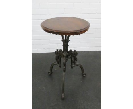 Late 19th / early 20th century circular top mahogany table raised on cast metal column and tripod supports 