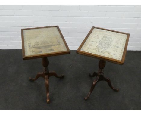 Pair of 19th century table mounted needlework samplers, housed under glass and raised on baluster columns and tripod legs, 62