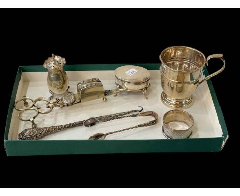 Silver christening mug, ring box, napkin ring, tongs and pepperette, and EP snuffers and button hook.