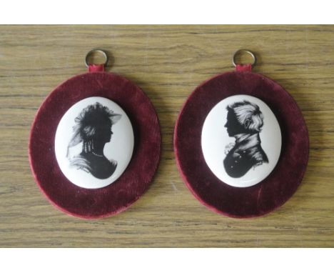 SILHOETTES - A pair of ceramic silhouettes mounted on red velvet by J Evans, for Staffordshire Fine Ceramics.