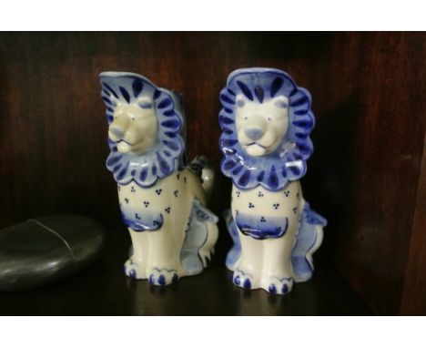 CERAMICS - A pair of blue & white ceramic jugs in the form of Lions. Each piece measures 16cm tall.
