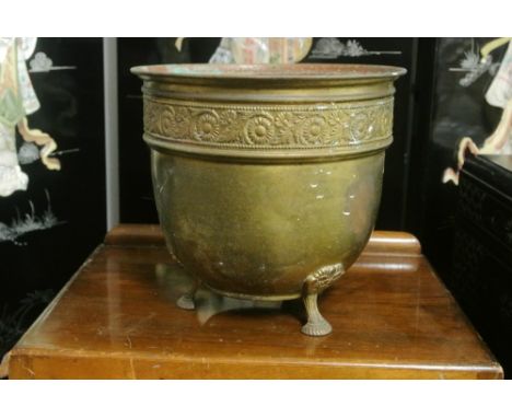FURNITURE/ HOME - A vintage brass planter with floral motif on tripod feet.