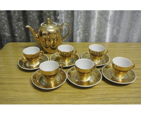 ANTIQUE/ TEACUPS - A collection of 6 matching gold coloured cups, saucers & teapot, stamped 'Foreign' to base.