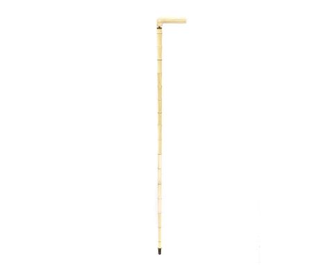 A sectional ivory walking stick, late 19th/ early 20th century, the handle above a faux bamboo shaft, with metal mounts, 88cm