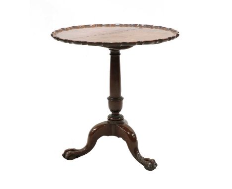 A George II mahogany tripod table, the circular top with a piecrust moulded rim, above a gun-barrel turned column and cabriol