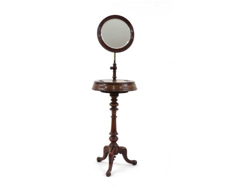 A Victorian mahogany gentleman's mirror on stand, the adjustable circular plate above hinged top on turned column and tripod 