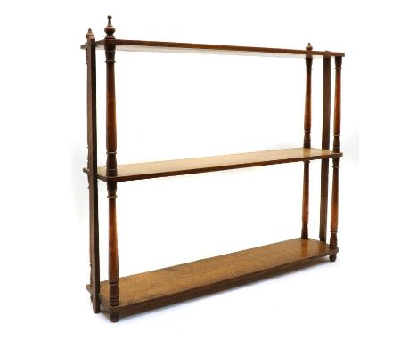 An early 20th century oak wall shelf, An early 20th century oak wall shelf, the three shelves supported by turned columns, 65