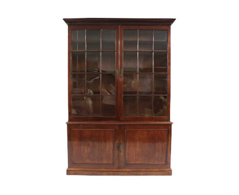 A mahogany bookcase, 19th century, the cornice with Greek key pattern, above geometric astragal glazed doors, with cupboards 