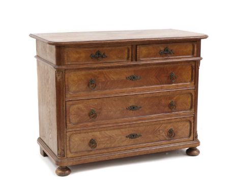 A 19th century French provincial oak commode chest, of two short above three long drawers, on bun feet, 109cm wide, 55cm deep