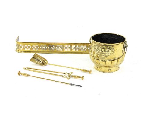 A collection of brass fireside items, to include an embossed coal bucket, 37cm diameter, 33cm high, together with a pierced f
