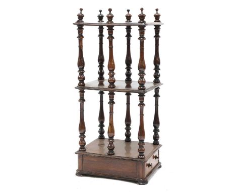 A Victorian rosewood whatnot, each rectangular shelf raised on six baluster supports, with a base drawer, on squat bun feet, 