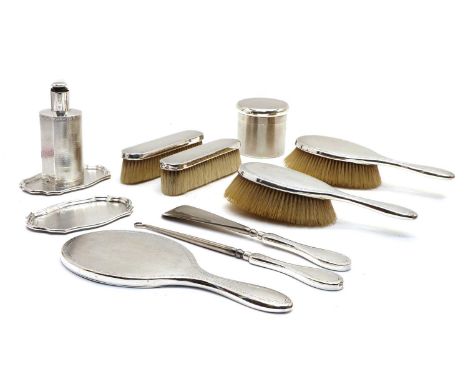 A silver dressing table set, London 1913, 14 and 15, Goldsmiths &amp; Silversmiths Co., comprising brushes, hand mirror, shoe