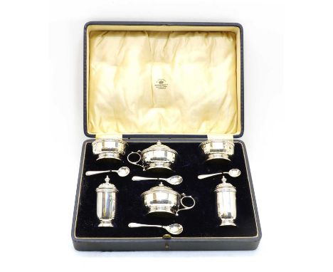 A cased silver cruet set, Birmingham 1931, Mappin &amp; Webb, of faceted form with a beaded edge, comprising two open salts a