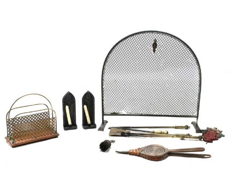 A set of three brass fire tools, early 19th Century, each with a twisted reeded handle, 62cm long together with a mesh fire s