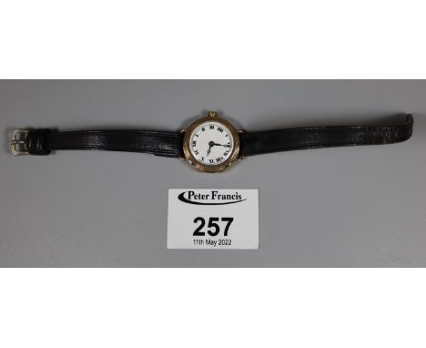 9ct gold ladies wrist watch with enamel face having Roman numerals, on a leather strap. 14g approx total weight including str