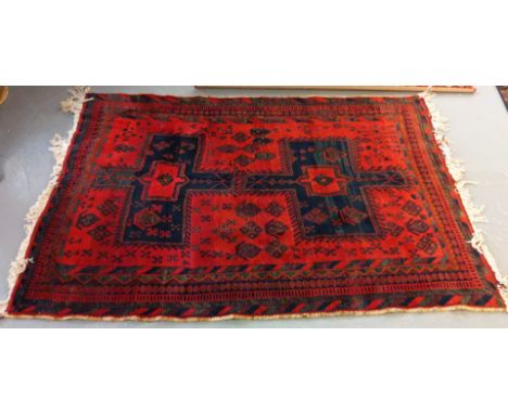 Middle eastern design red ground carpet having geometric floral and foliate designs. (B.P. 21% + VAT)