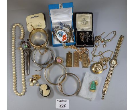 A collection of vintage costume jewellery in a tin including an, ?Aseikon? manual pendant watch.(B.P. 21% + VAT) 
