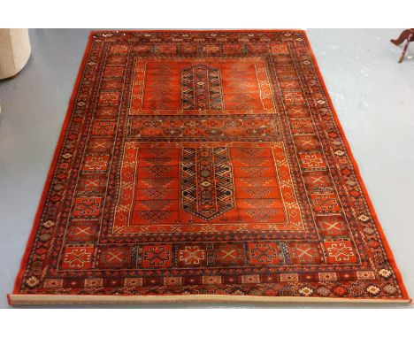 Large middle eastern design red ground carpet having geometric floral and foliate designs 292x200cm approx (B.P. 21% + VAT)&n