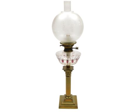 An early 20thC Hinks's Duplex glass oil lamp, of Corinthian column form, with a clear and red tinted cut glass reservoir, wit