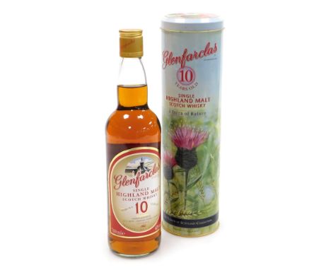 A bottle of Glenfarclas Single Highland Malt Scotch Whisky, 10 years old, 70cl, in a tin canister.