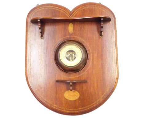 An Edwardian mahogany and inlaid shield shaped hall mirror, with two shaped shelves and brass hanging hooks, the central mirr