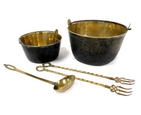 A heavy brass jam pan, with cast iron handle, 32.5cm wide, a smaller jam pan, ladle and two toasting forks. (5) 
