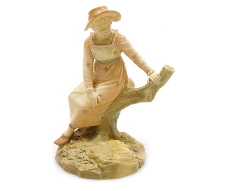 A Hadley's Royal Worcester blush porcelain figure of a girl, modelled seated on the bough of a tree, raised on a naturalistic