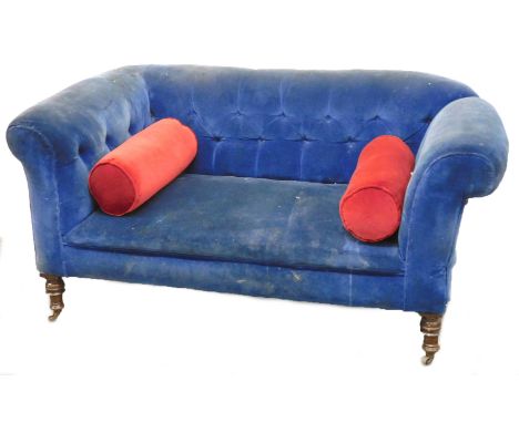 A Victorian mahogany two seater sofa, upholstered in blue button back draylon, raised on turned legs, on castors, 153cm wide.