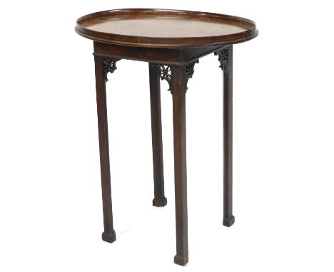 A Chippendale style mahogany night table, with an oval tray top, over a single candle slide, raised on square legs, united by