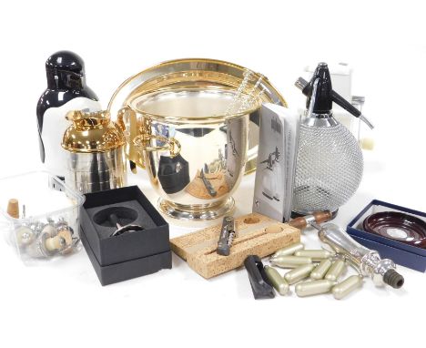 A group of bar items, including a silver plated wine cooler, Swing-a-way ice crusher, soda siphon, Metrokane penguin jug, and