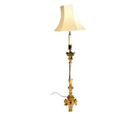 A brass standard lamp, of Gothic altar form, with a floral cream shade, 180.5cm high.