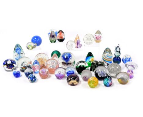 A group of late 20thC glass paperweights, various sizes and decoration, and a pair of New Zealand jade (green stone) paperwei