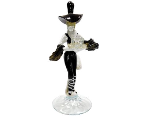 A Murano glass candlestick, of a figure in black and white striped trousers, stylised hat and puffed sleeves, raised on a cir