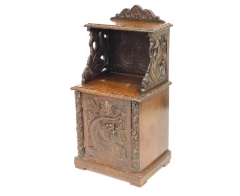 A Victorian oak pot cupboard, with a small shelf over foliate and acanthus leaf carved back and sides, above a cupboard with 