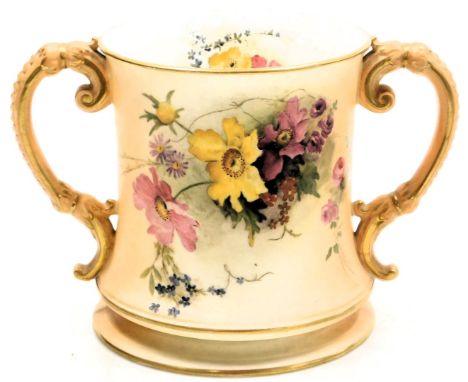 A Royal Worcester blush porcelain loving cup, c1918, painted with meadow flowers, printed and painted marks, 15cm high.